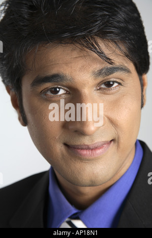 Executive man face looking at camera smiling black coat blue shirt dpa 200009 ang Stock Photo