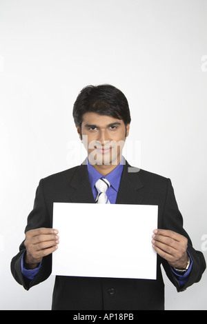 Blank paper - Executive holding blank white paper with both hands wearing black suit - Model release No 687M Stock Photo