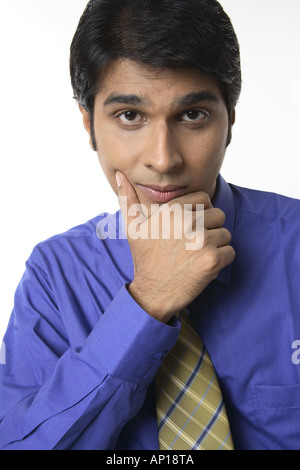 ANG200047 Executive resting on a chair thinking holding his chin Stock Photo