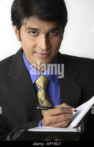 ANG200089 Executive holding diary and pen Model release No 687M Stock Photo
