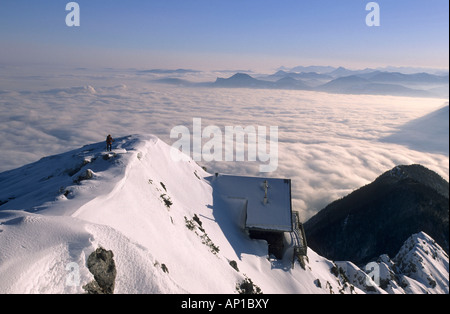 View from summit of Hochstaufen to hut Reichenhaller Haus and Salzkammergut, fog down in Salzburg, Chiemgau range, Chiemgau, Bav Stock Photo