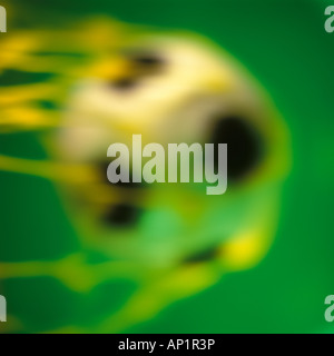 A football hitting the back of the net Stock Photo