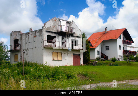 Destruction and construction A shelled and burned off house during the war in Croatia Yugoslavia and a newly build house Stock Photo