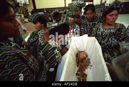 Mayan women crying over the remains of relatives killed in a massacre by Guatemala soldiers Stock Photo