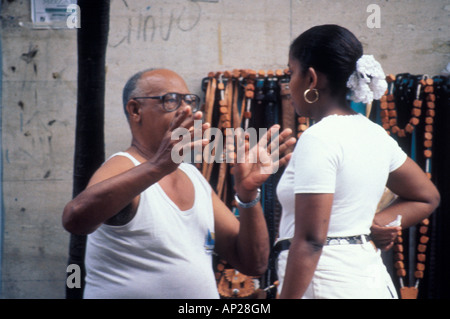 Animated conversation between an elderly man and a young woman in Santo Domingo Dominican Republic Stock Photo