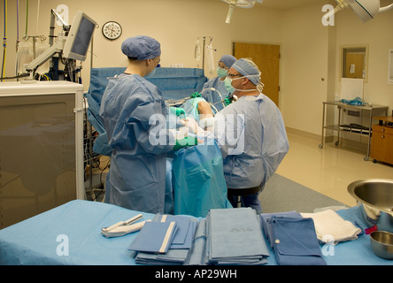 Surgical team performing arthroscopic knee surgery in hospital operating room Stock Photo