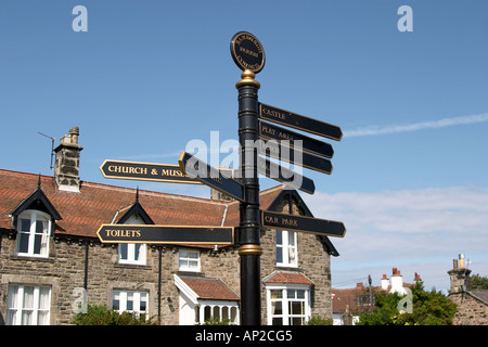 Tourist Sign in Bamburgh Northumberland UK showing directions to places of interest Stock Photo