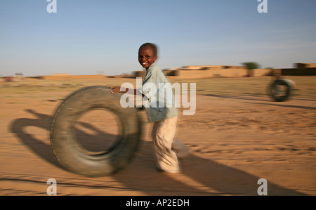 Refugee children playing with their toys Stock Photo