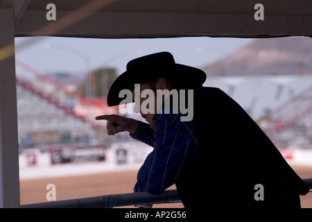 Cowboy watches the Tucson Rodeo competition Stock Photo
