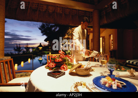 Waiter serving wine for a private dinner, Royal Villa, Hotel Oberoi, Holiday, Mauritius, Africa Stock Photo