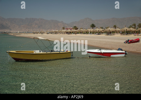 Three small powerboats used for water sports activities moored at the Coral Hilton Resort beach in Nuweiba Egypt Stock Photo
