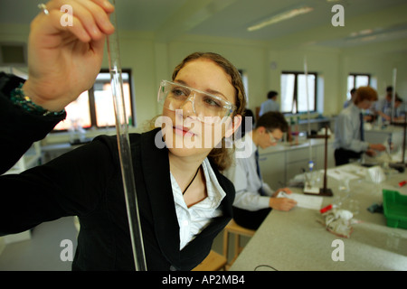 Attractive female student in chemistry lesson at Colyton Grammar School in Devon UK Stock Photo