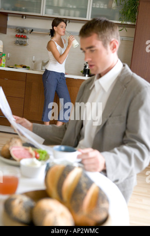 couple eating breakfast separately Stock Photo
