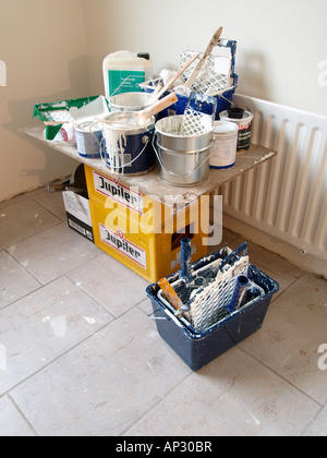Paint cans and buckets on Jupiler beer crates during house home renovation Stock Photo