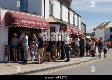 Lunchtime queue to buy Cornish pasties from a bakery in Tintagel Cornwall Stock Photo