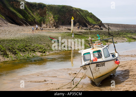 Fishing boat on the beach at low tide in Bude north Cornwall Stock Photo