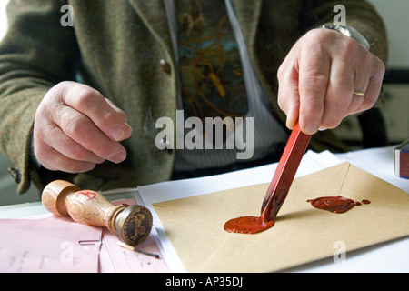 Notary fixes a seal on a document, last will and testament, inheritance seal, sealing wax