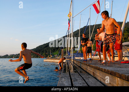 young men diving from landing stage, lake Attersee, Salzkammergut, Salzburg, Austria Stock Photo