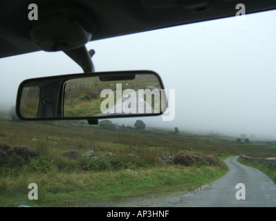 concept image of car on loenly country lane Stock Photo