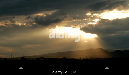 dramatic sunset sunrise sun rays through clouds natural nature scenic sky cloud weather cloudy high skyscraper landscape travel Stock Photo