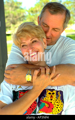 Couple age 54 embracing on The Great River State Park Bike Trail. Onalaska Wisconsin WI USA Stock Photo