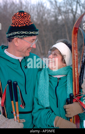 Couple age 58 with cross country skies at Plymouth Park Reserve. Plymouth Minnesota MN USA Stock Photo