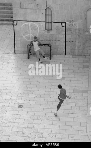 Two Kids playing urban football in Dubrovnik Centre in Croatia Stock Photo