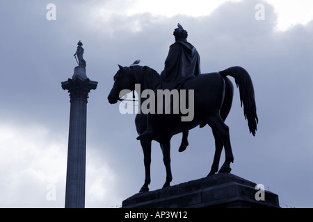 nelsons column and statue of man on horse in trafalgar square london england uk Stock Photo