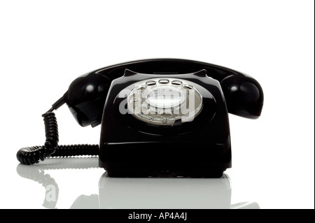 Retro black telephone on a white surface with reflection Stock Photo