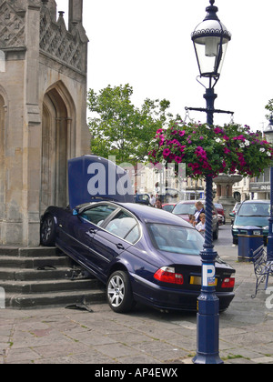 a runaway blue BMW saloon car in market place Wiltshire England UK Stock Photo