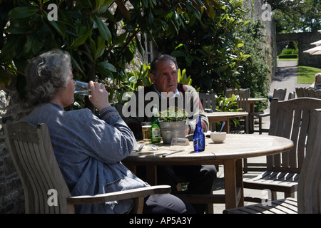 Couple at cafe table overlooking the Pool Garden at Aberglasney House and Gardens, Llangathen, Camarthenshire, West Wales, Stock Photo