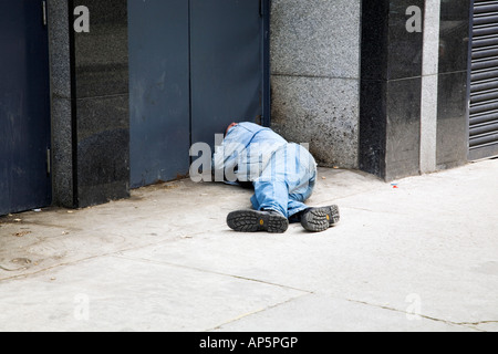 Homeless man sleeping in doorway in inner city Dublin Ireland Stock Photo