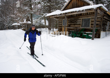 A skier makes his way past the visitor cabins at the AMC's Little Lyford Pond Camps in Maine's Northern Forest. (MR) Stock Photo