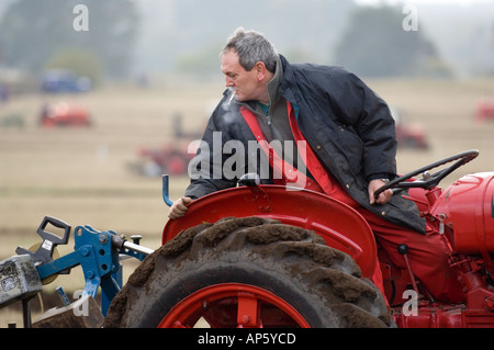 Man ploughing with a vintage tractor Stock Photo