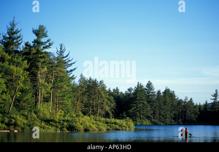 Freedom, NH Fly-fishing from a canoe in Trout Pond. Part of future town forest. (MR) Stock Photo