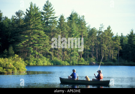 Freedom, NH Fly-fishing from a canoe in Trout Pond. Part of future town forest. (MR) Stock Photo