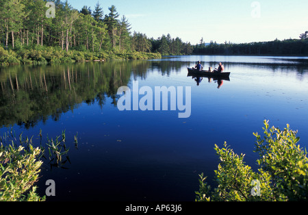 Freedom, NH Fly-fishing from a canoe in Trout Pond. Part of future town forest. (MR) Stock Photo