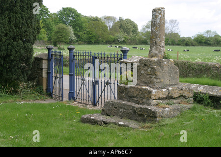 Base of ancient cross in churchyard of Langford church in Oxfordshire Stock Photo