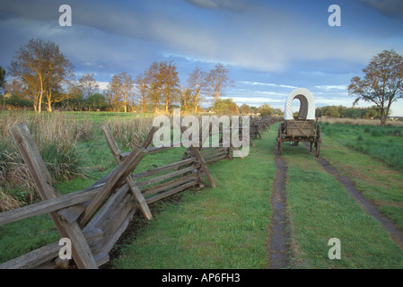 A replica wagon at sunrise along the Original Oregon Trail found at Whitman Mission National Historic Site. Stock Photo