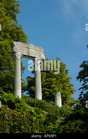 The remains of a Roman building standing isolated and mysterious in the woods Space for text in the sky Stock Photo