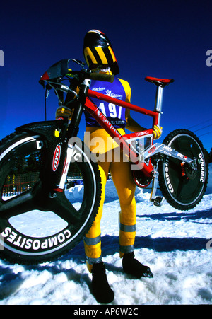 Mountain biker holds bike frame in snow,  Big Bear resort, California Stock Photo