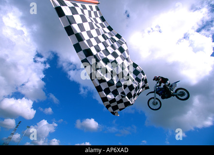 Motocross stunt action against blue sky