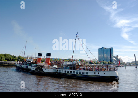 The Waverly about set off on a summer cruise turning around as it is towed out of the quayside Stock Photo