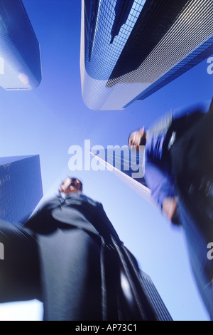 Business partners moving through Los Angeles skyscrapers Stock Photo