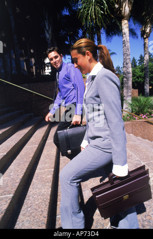 Businessman and women walking up stairs in downtown Los Angeles Stock Photo