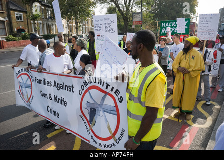Community march against gun and knife crime in Hackney, London, goes along a street notorious for several murders. Stock Photo