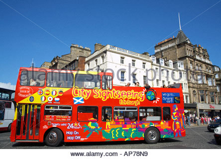 A red tourist bus travels along Princes Street, Edinburgh SCOTLAND Stock Photo