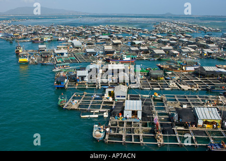 Floating Village Houseboats with Fish Farms in Lingshui China Stock Photo