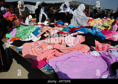 Israel Beer Sheva the Bedouin market woman in traditional dress buying children s clothes Stock Photo