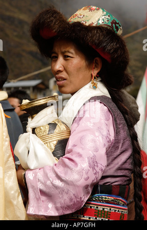 A Tibetan woman in a silk hat lined with red fox fur called a Lhakkya